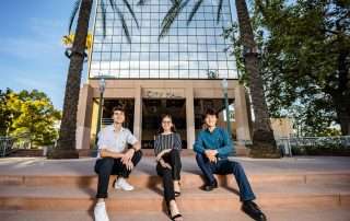 3 student ambassadors sitting in front of City Hall