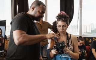 Photographer and intern looking into a digital camera