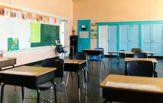 A primary school classroom with empty desks