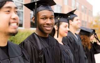 Young graduates smiling